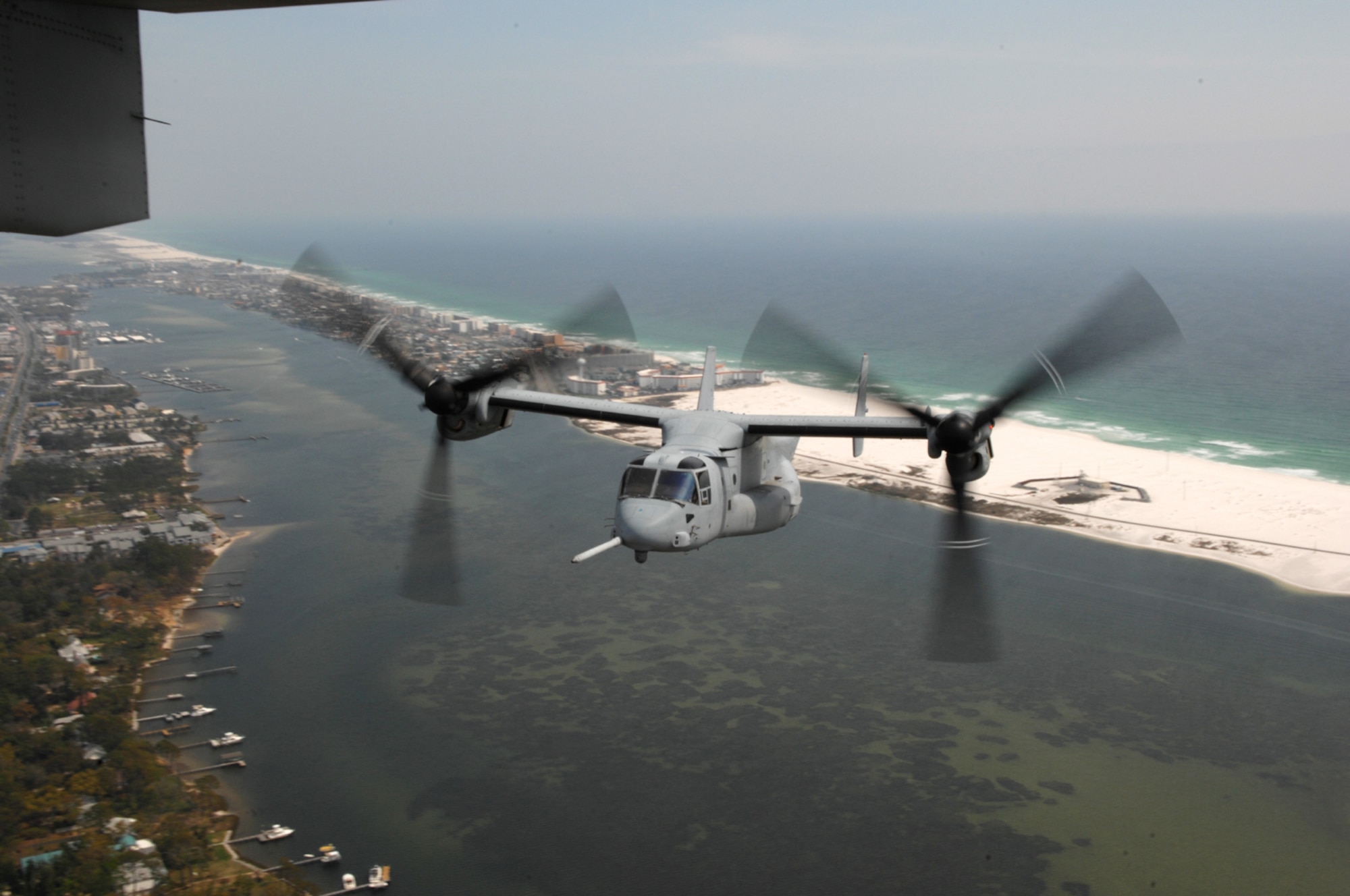 A Marine MV-22 Osprey flies over the sound during a training session March 30. Eight MV-22s arrived at Hurlburt Field March 27 for nearly two weeks of training. The MV-22 is a sister aircraft to Hurlburt's CV-22. (U.S. Air Force photo by Senior Airman Andy Kin)