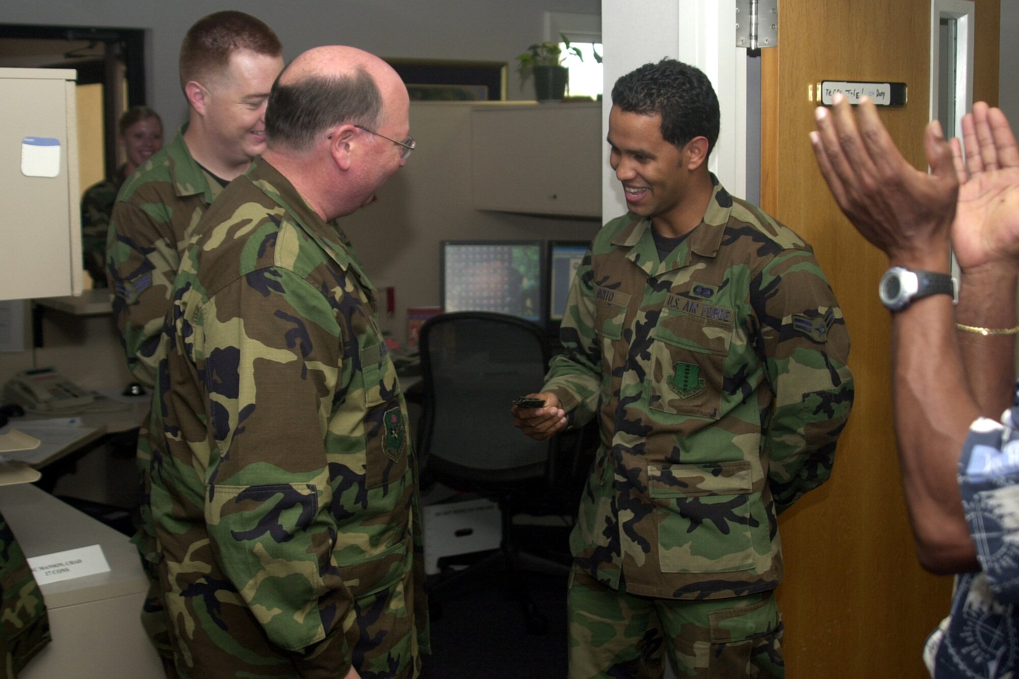 Col. Richard Ayres, 17th Training Wing commander (left), presents Airman 1st Class Julio Brito, of the 17th Contracting Squadron, with this senior airman stripes March 29. Airman Brito was promoted below-the-zone. (U.S. Air Force photo by Airman 1st Class Stephen Musal)