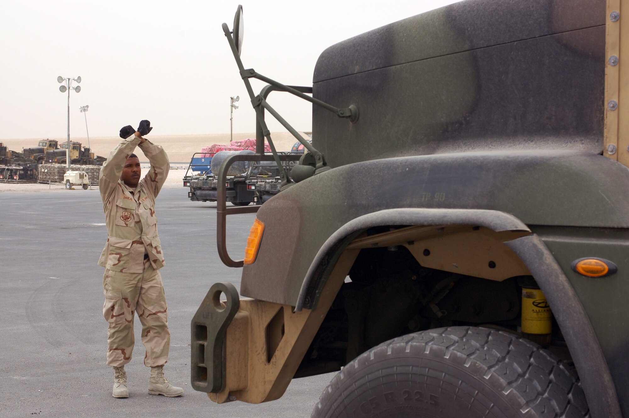 Tech. Sgt. Garth Chablal, 8th Expeditionary Air Mobility Squadron air freight supervisor, guides one of 32 M916 trucks onto scales for weighing in preparation for shipment on C-17 Globemasters. Squadrons across the 379th Air Expeditionary Wing have picked up operations along with surge operations in Iraq and Afghanistan. (U.S. Air Force photo by Senior Airman Erik Hofmeyer) 