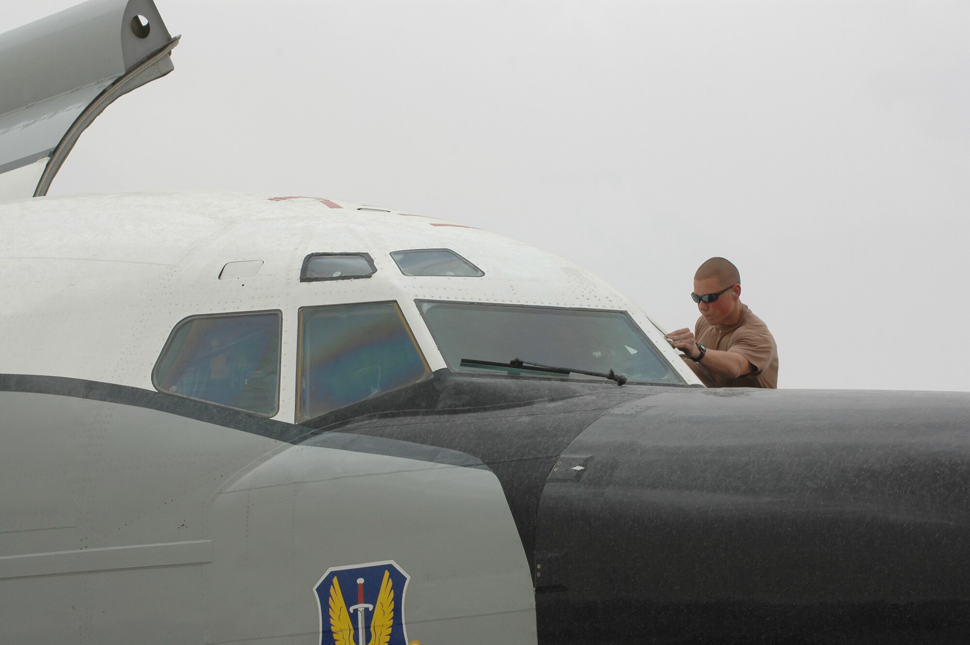 Airman 1st Class Curtis Green, 55th Aircraft Maintenance Unit crew chief, cleans off the windshield of an RC-135 Rivet Joint Wednesday. (U.S. Air Force photo by Senior Airman Erik Hofmeyer)