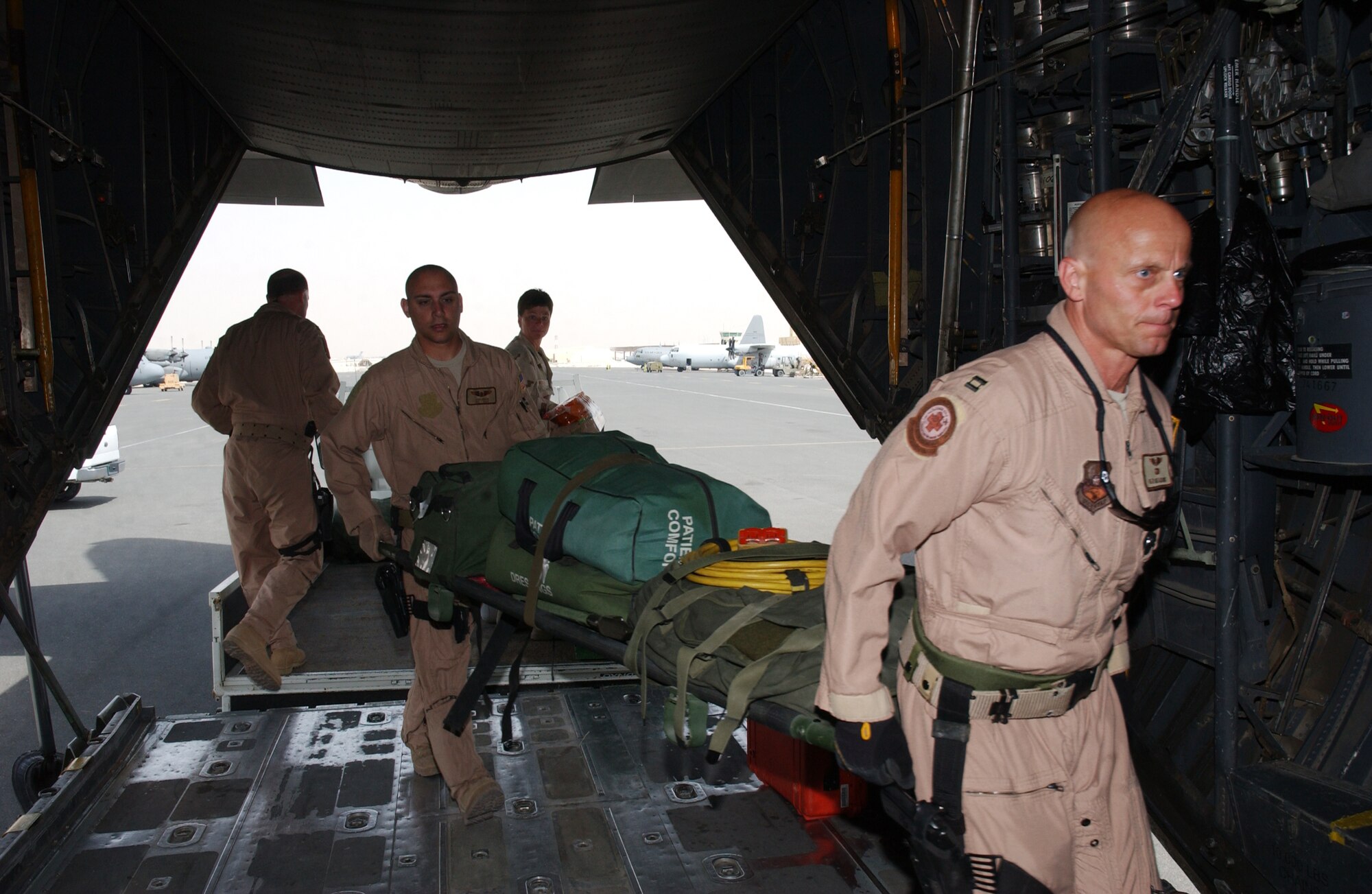 Capt. Ben Meadows (right), 379th Expeditionary Aeromedical Evacuation Squadron flight nurse, and Senior Airman Josh Green, 379th EAES technician, load up a C-130 Hercules with medical supplies and equipment in preparation for a mission in Southwest Asia. The Air National Guardsmen are part of a Total Force team comprised of active duty, Reserve and Air National Guard personnel. About 90 percent of Air Force aeromedical evacuation personnel and assets are from the Reserve components. (Photo by Tech. Sgt. Deborah Davis)
