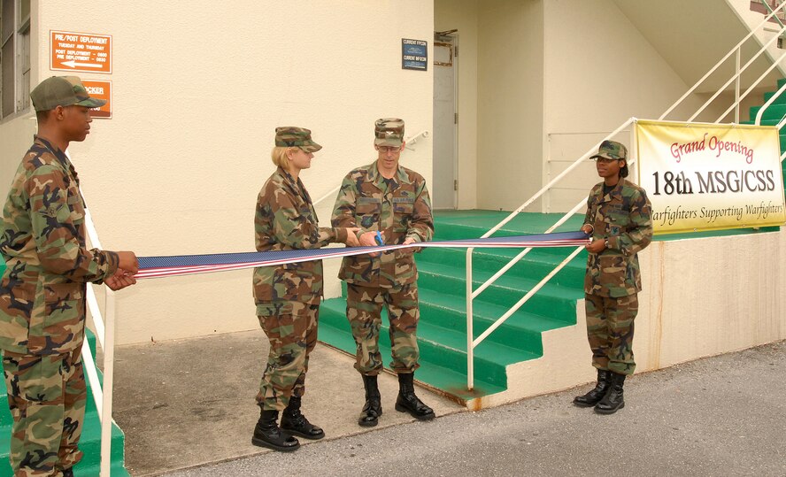 KADENA AIR BASE, Japan -- Col. Max Kirschbaum, 18th Mission Support Group commander, cuts the ribbon on the new 18th MSG Commander's Support Staff office located in building 721B. (Air Force/Airman 1st Class Ryan Ivacic) 