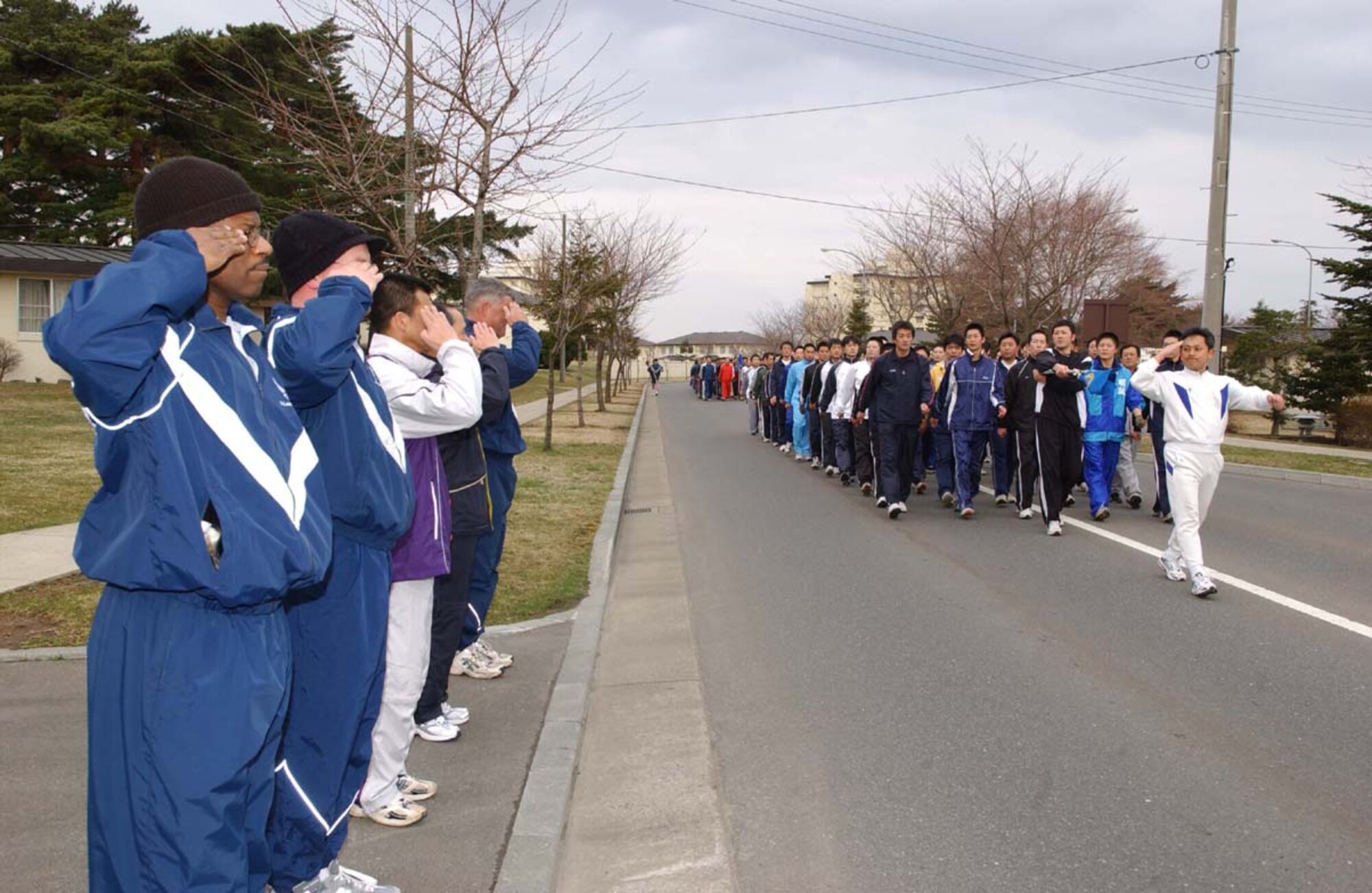 070406-MISAWA AB, JAPAN -- A Japanese Air Self Defense Force flight leader salutes Misawa Air Base leadership during pass and review after a two mile readiness run here. Nearly 3,000 U.S. Air Force, Navy and Army service members ran with Japanese Air Self-Defense Force personnel in the first readiness run of 2007. The participation in the monthly readiness run reflects the camaraderie and dedication toward the strong alliance between both countries.
(U.S. Air Force photo by Senior Airman Robert Barnett)
