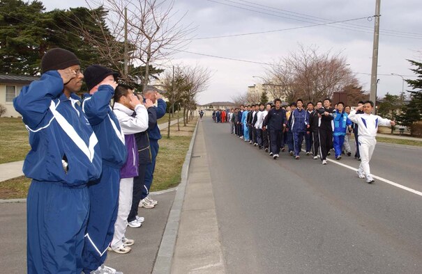 070406-MISAWA AB, JAPAN -- A Japanese Air Self Defense Force flight leader salutes Misawa Air Base leadership during pass and review after a two mile readiness run here. Nearly 3,000 U.S. Air Force, Navy and Army service members ran with Japanese Air Self-Defense Force personnel in the first readiness run of 2007. The participation in the monthly readiness run reflects the camaraderie and dedication toward the strong alliance between both countries.
(U.S. Air Force photo by Senior Airman Robert Barnett)