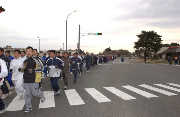 070406- MISAWA AB, JAPAN -- Japanese Air Self-Defense Force personnel run in formation along Falcon Drive in the first readiness run of 2007. Nearly 3,000 U.S. and Japanese service members ran the two-mile course here April 6. The participation in the monthly readiness run reflects the camaraderie and dedication toward the strong alliance between both countries.
(U.S. Air Force photo by Senior Airman Robert Barnett)
