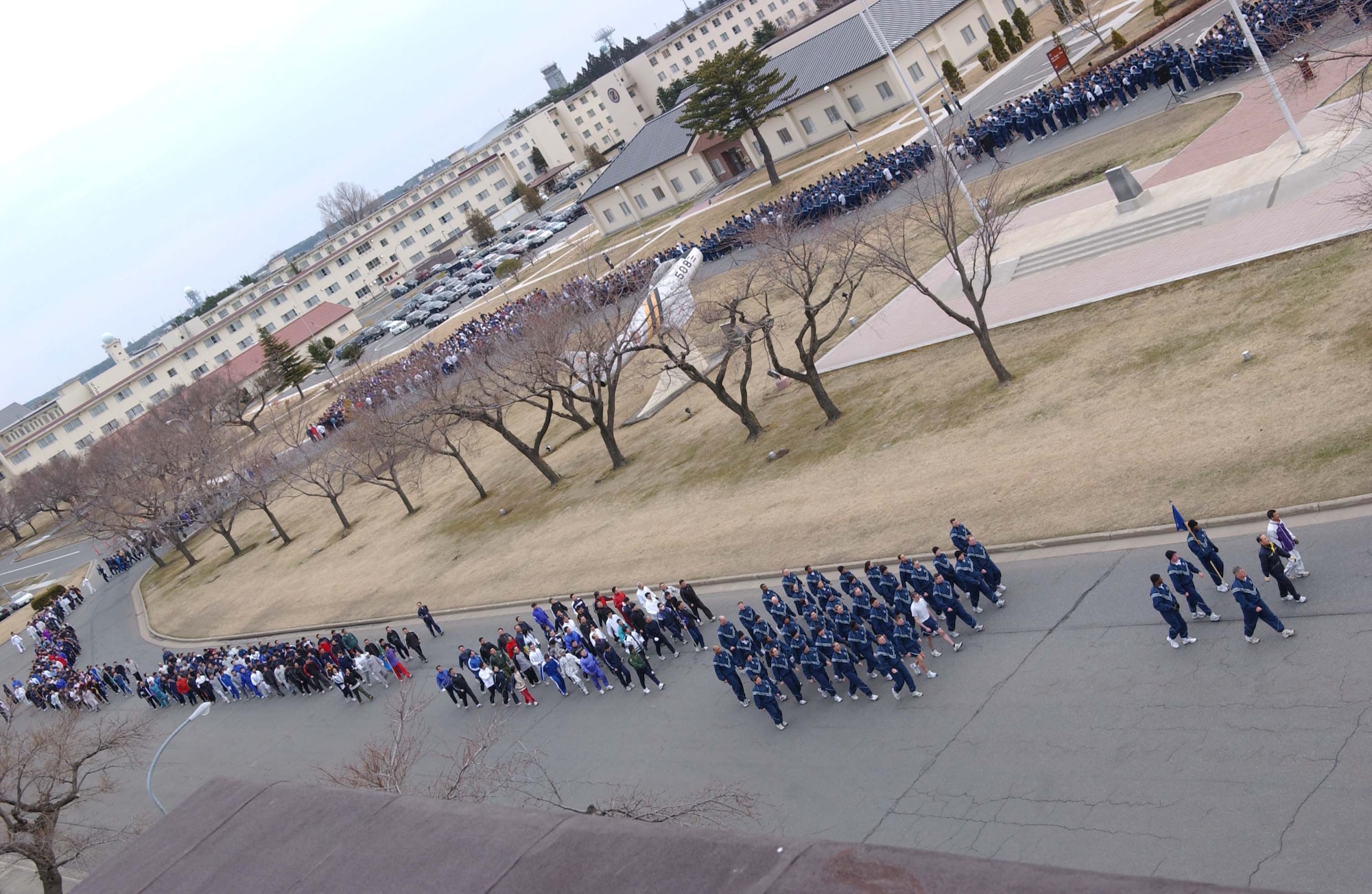 070406 - MISAWA AB, JAPAN -- U.S. Air Force, Navy and Army service members run with Japanese Air Self-Defense Force personnel in the first readiness run of 2007. Nearly 3,000 service members ran the two-mile course here April 6. The participation in the monthly readiness run reflects the camaraderie and dedication toward the strong alliance between both countries.
(U.S. Air Force photo by Senior Airman Robert Barnett)
