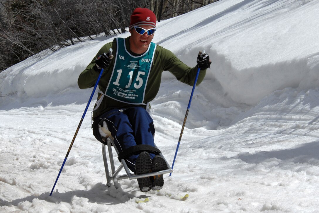 A Veteran Affairs volunteer takes aim at his target while he cross country skis during the cross country skiing, snowshoeing ,and shooting biathlon event during the National Disabled Veterans Winter Sports Clinic in Snowmass, Colo., April 3, 2007.