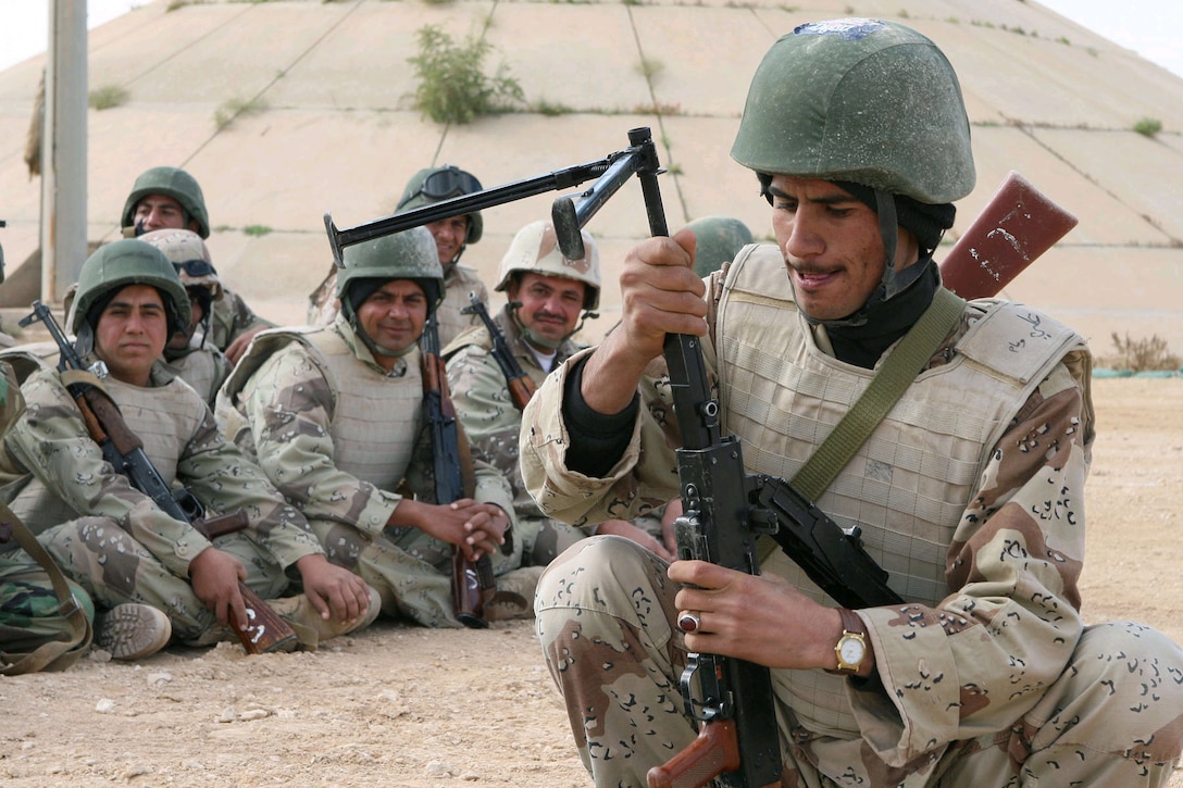 Directly following a class on the PKC machine gun, students in the Iraqi Army School of Infantry race to break down and re-assemble the weapon, April 4, 2007.