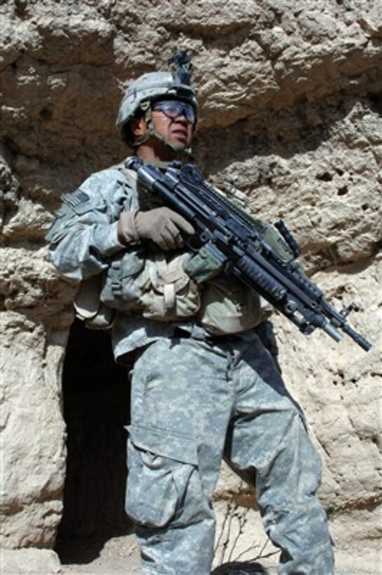 U.S. Army Spc. Ham stands guard outside while fellow soldiers search a cave during a patrol in the Paktika province of Afghanistan on March 29, 2007.  The patrol is part of a mission intended to disrupt enemy movement in areas known to have enemy activity.  The soldiers are assigned to Charlie Company, 2nd Battalion, 87th Infantry Regiment, 10th Mountain Division.  
