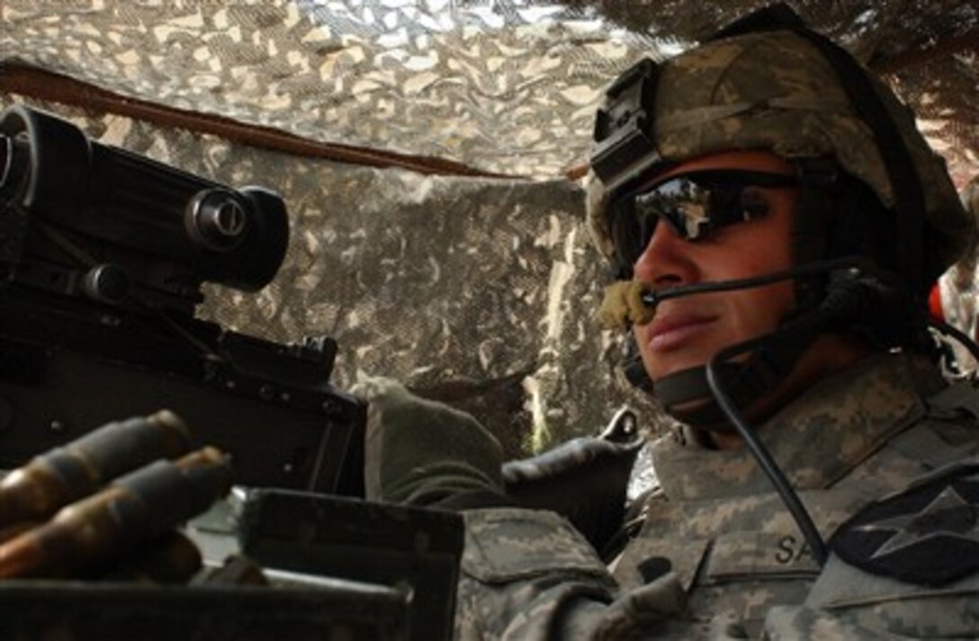 U.S. Army Spc. Ian Sage provides security from the hatch of a Stryker vehicle in Mansour, Iraq, on April 4, 2007, during a combined cordon and search mission with Iraqi army soldiers.  Sage is assigned to Black Hawk Company, 1st Battalion, 23rd Infantry Regiment, 2nd Infantry Division.  