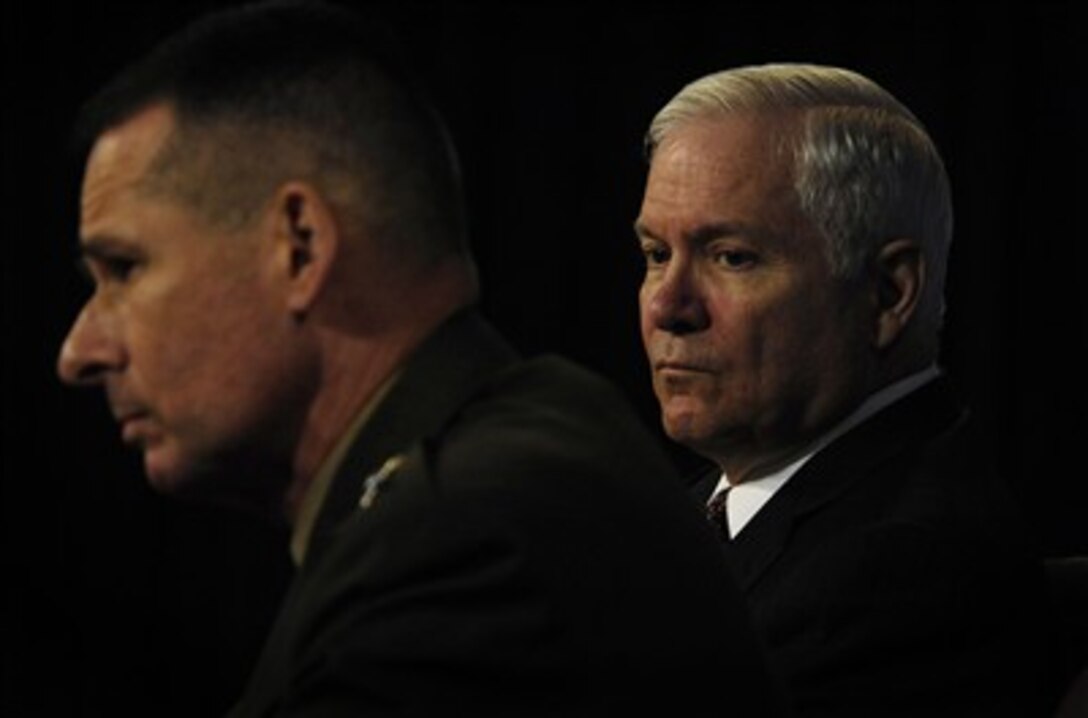 Secretary of Defense Robert M. Gates (right) listens as Chairman of the Joint Chiefs of Staff Gen. Peter Pace, U.S. Marine Corps, responds to a question from a reporter during a press briefing in the Pentagon on April 5, 2007.  