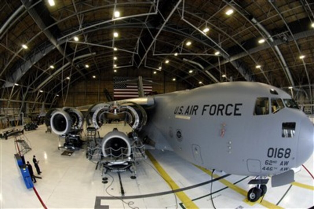 A C-17 Globemaster III sits in a hangar at McChord Air Force Base Wash. as jet engine mechanics assigned to the 62nd Maintenance Squadron prepare to install a repaired engine during a home station inspection April 2, 2007.