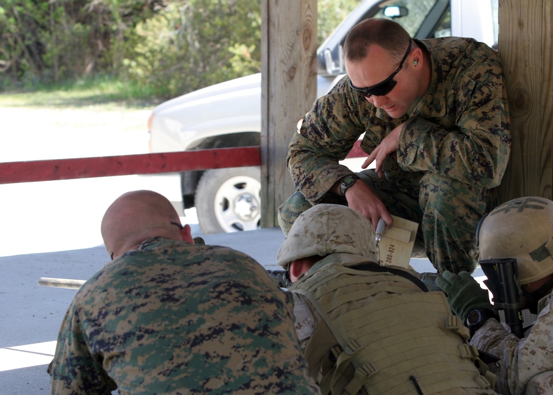 Marine Corps Special Operations Training Group sniper instructor, Sgt. Kenneth R. Burdine (right), coaches a student during the Urban Sniper Course team-assault course of fire held aboard Camp Lejeune, N.C., April 5, 2007.  Two-man teams assaulted through the "Dodge City" multipurpose shooting range as a part of the course and were graded on their abilities to accurately engage multiple targets with precision weapons.  (U.S. Marine Corps photo by Cpl. Peter R. Miller)