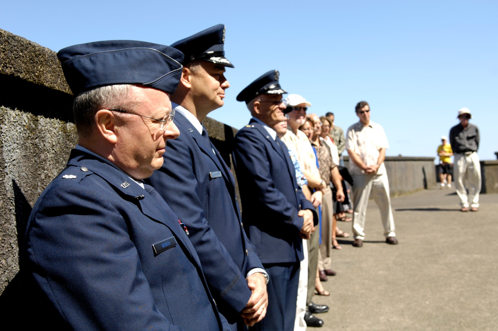 Hickam Air Force Base Airmen and Hawaii Aviation Preservation Society members listen to a speech during a memorial ceremony at Nu'uanu Pali Lookout, Hawaii April 5, 2007. Airmen and HAPS members held a memorial and dedicated a plaque for 10 crew members of a B-17E Flying Fortress that crashed into the cliffs of Mt. Keahiakahoe 65 years ago. (U.S. Air Force photo/ Tech. Sgt. Shane A. Cuomo)