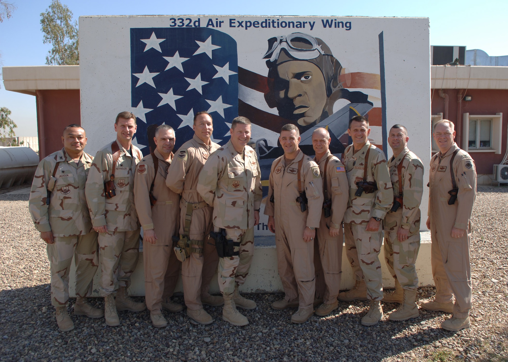 BALAD AIR BASE, Iraq - Senior leaders of the 332nd Air Expeditionary Wing pose for a command shot during Brig. Gen. Burton Field's visit to Tuskegee Airmen April 2 to 6. From left are Cols. Larry Jackson, David Reynolds, Scott Dennis, Chief Master Sgt. Tim Reuning, current commander Brig. Gen. Robin Rand, incoming commmander Brig. Gen. Burton Field, Cols. Gary Renfrow, Tim Fowler, Brian Masterson and Kevin Bradley. Collectively, the gentlemen are known as Red Tail 1 through 8 in honor of the legendary World War II Tuskegee Airmen whose P-51 Mustang's tail flashes were painted bright red. (U.S. Air Force photo/Staff Sgt. Michael R. Holzworth)