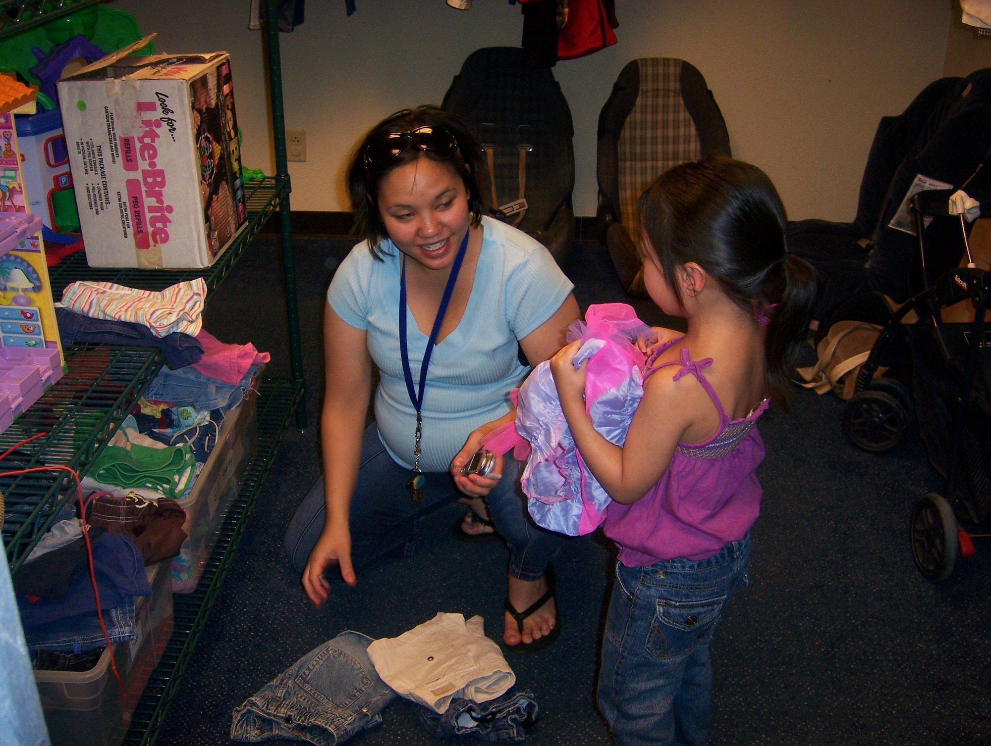 An Andersen mother selects new clothes for her daughter at the Airman’s Attic.  Donors supply the Attic with a wide variety of items such as military uniforms, household goods, sporting equipment, and  more.  The Airman’s Attic is open from 11 a.m. to 3 p.m. Monday through Friday and from 9 a.m. to noon the second and fourth Saturday each month. (U.S. Air Force photo by Airman 1st Class Carissa Morgan/36th Wing Public Affairs)