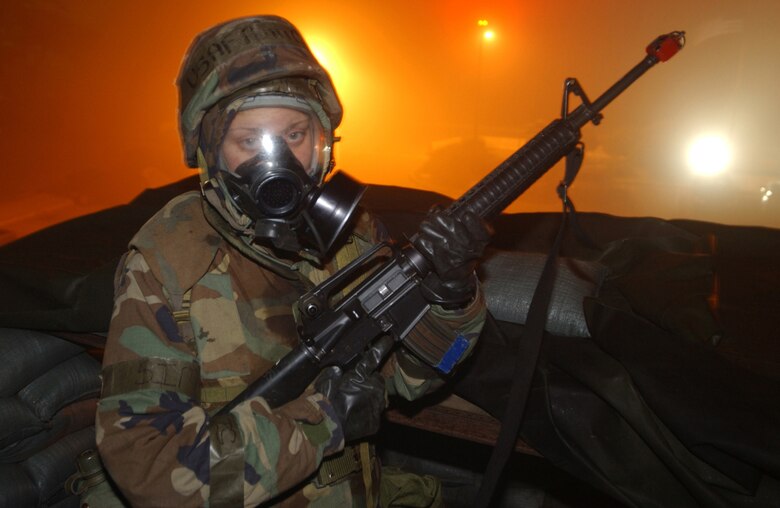 KUNSAN AIR BASE, Republic of Korea  March 27, 2007 -- Amn. Leah Cash, 8th Logistics Readiness Squadron, remains vigilant as she keeps a keen eye out for enemy ?coyotes? at her post on top of the wing headquarters building March 27. Coyotes is the term given to mock enemy forces during an exercise here. The Wolf Pack, as the 8th Fighter Wing is known as, participated in a week-long Operational Readiness Exercise in preparation for April?s Operational Readiness Inspection. (Air Force photo/Senior Airman Darnell Cannady)