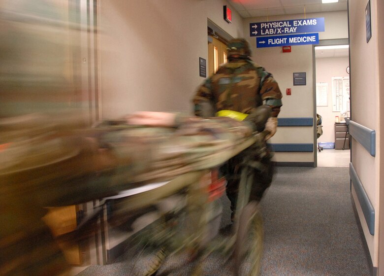 KUNSAN AIR BASE, Republic of Korea  March 26, 2007 -- A simulated patient is rushed for X-rays after being transported to the clinic March 26. The Wolf Pack, as the 8th Fighter Wing is known as, participated in a week-long Operational Readiness Exercise in preparation for April?s Operational Readiness Inspection. (Air Force photo/Master Sgt. Jack Braden)