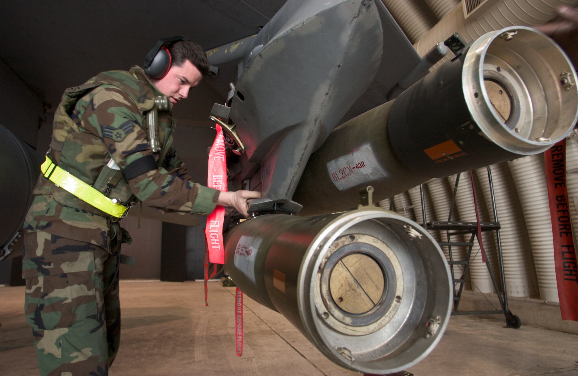 KUNSAN AIR BASE, Republic of Korea  March 26, 2007 -- Senior Airman Jason Cook, 8th Aircraft Maintenance Squadron weapons technician, inspects a Guided Bomb Unit-12 on an F-16 March 26. (Air Force photo/Senior Airman Barry Loo)