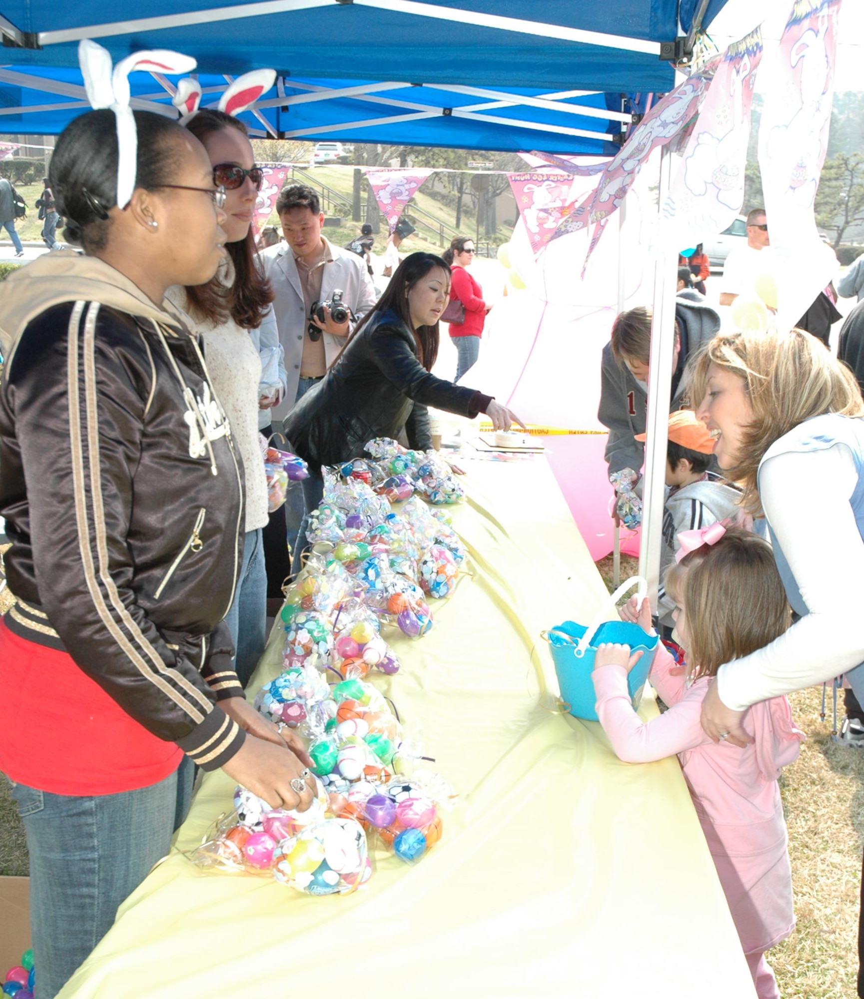 OSAN AIR BASE, Republic of Korea --  Volunteers hand out candy to children at the Easter Egg Hunt at Turumi Park on Saturday. The 51st Services Squadron hosted the event, which allowed children to trade plastic eggs for candy. (U.S. Air Force photo by Staff Sgt. Benjamin Rojek)
