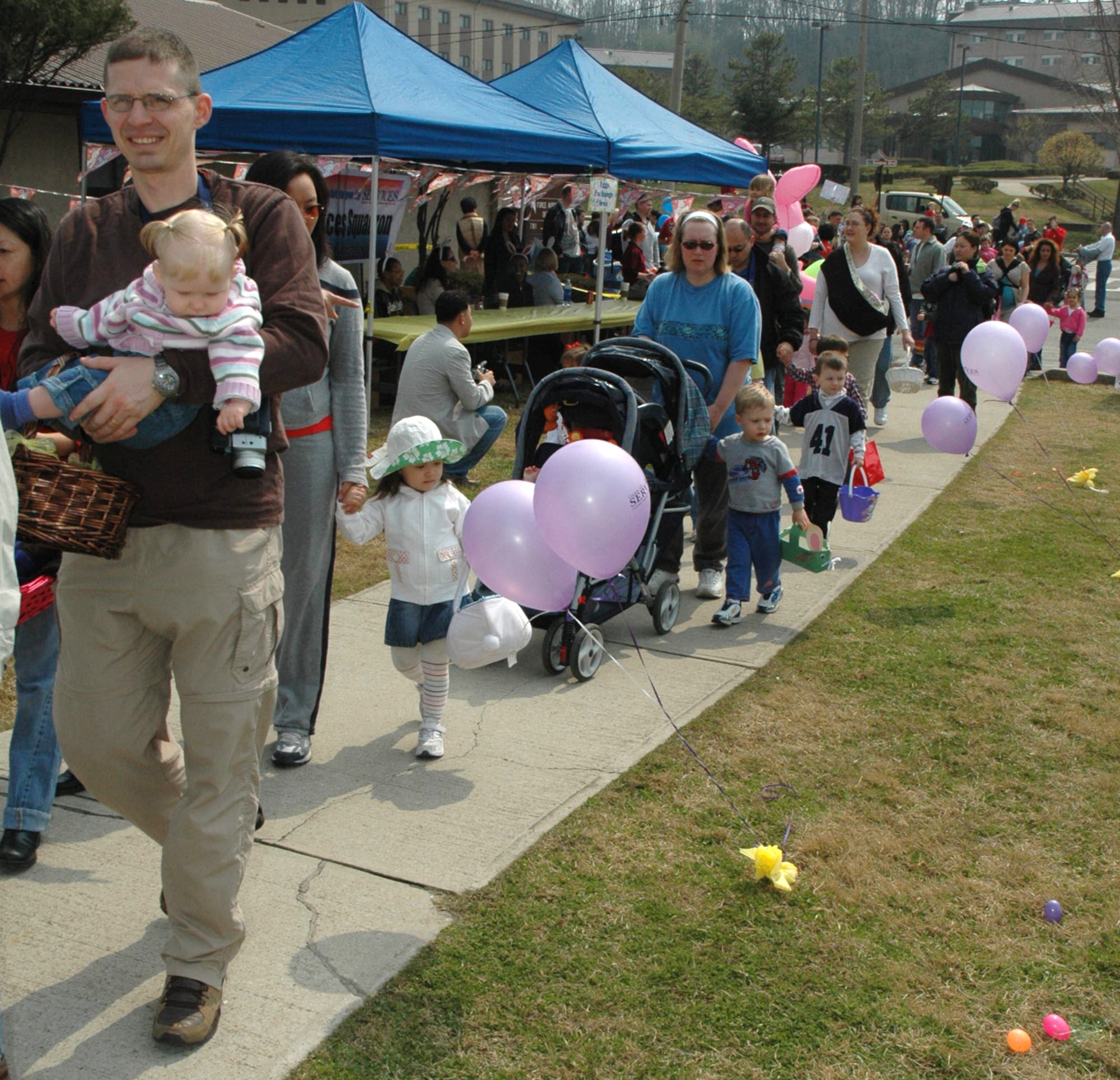 OSAN AIR BASE, Republic of Korea --  Parents and children enter Turumi Park at the beginning of the Easter Egg Hunt Saturday. The 51st Services Squadron hosted the egg hunt, which allowed children to trade plastic eggs for candy. (U.S. Air Force photo by Staff Sgt. Benjamin Rojek)