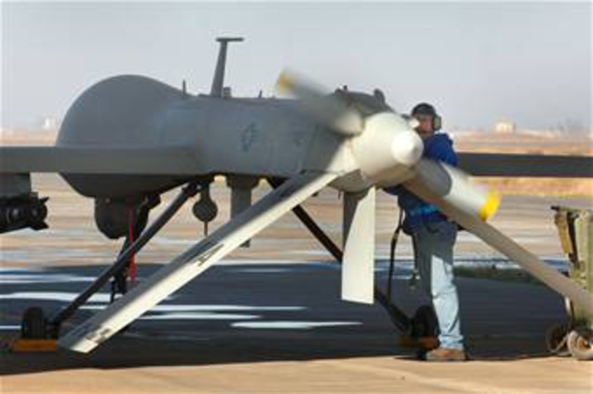 Bruce Ottenwess conducts pre-flight checks before launching the MQ-1 Predator Unmanned Aerial Vehicle recently from Balad Air Base, Iraq. Mr. Ottenwess is a General Atomics Aeronautical Systems Airframe and power plant mechanic based out of Creech Air Force Base, Nev. (U.S. Air Force photo/Staff Sgt. Michael R. Holzworth)
