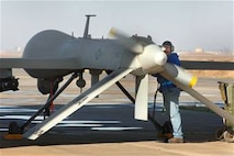Bruce Ottenwess conducts pre-flight checks before launching the MQ-1 Predator Unmanned Aerial Vehicle recently from Balad Air Base, Iraq. Mr. Ottenwess is a General Atomics Aeronautical Systems Airframe and power plant mechanic based out of Creech Air Force Base, Nev. (U.S. Air Force photo/Staff Sgt. Michael R. Holzworth)