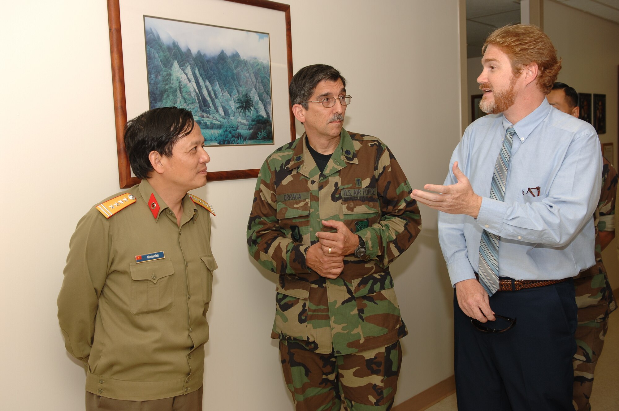 HICKAM AIR FORCE BASE, Hawaii -- Lt. Col. Guillermo Orraca, 15th Airlift Wing Medical Group, briefed Brig. Gen. DO Hoa Binh on the Dental Services at the 15MDG, through Mr. Ron Ward, a Linguist Specialist at JPAC.  Linguists are critical in Subject Expert Exchange such as this.  This visit is part of the nursing exchange program which started at the 15th Annual Asia-Pacific Military Medical Conference where the Vietnamese requested that the two countries develop a cooperative relationship between the U. S. and Vietnamese Military Nursing communities. (Air Force photo by Mark Bates)