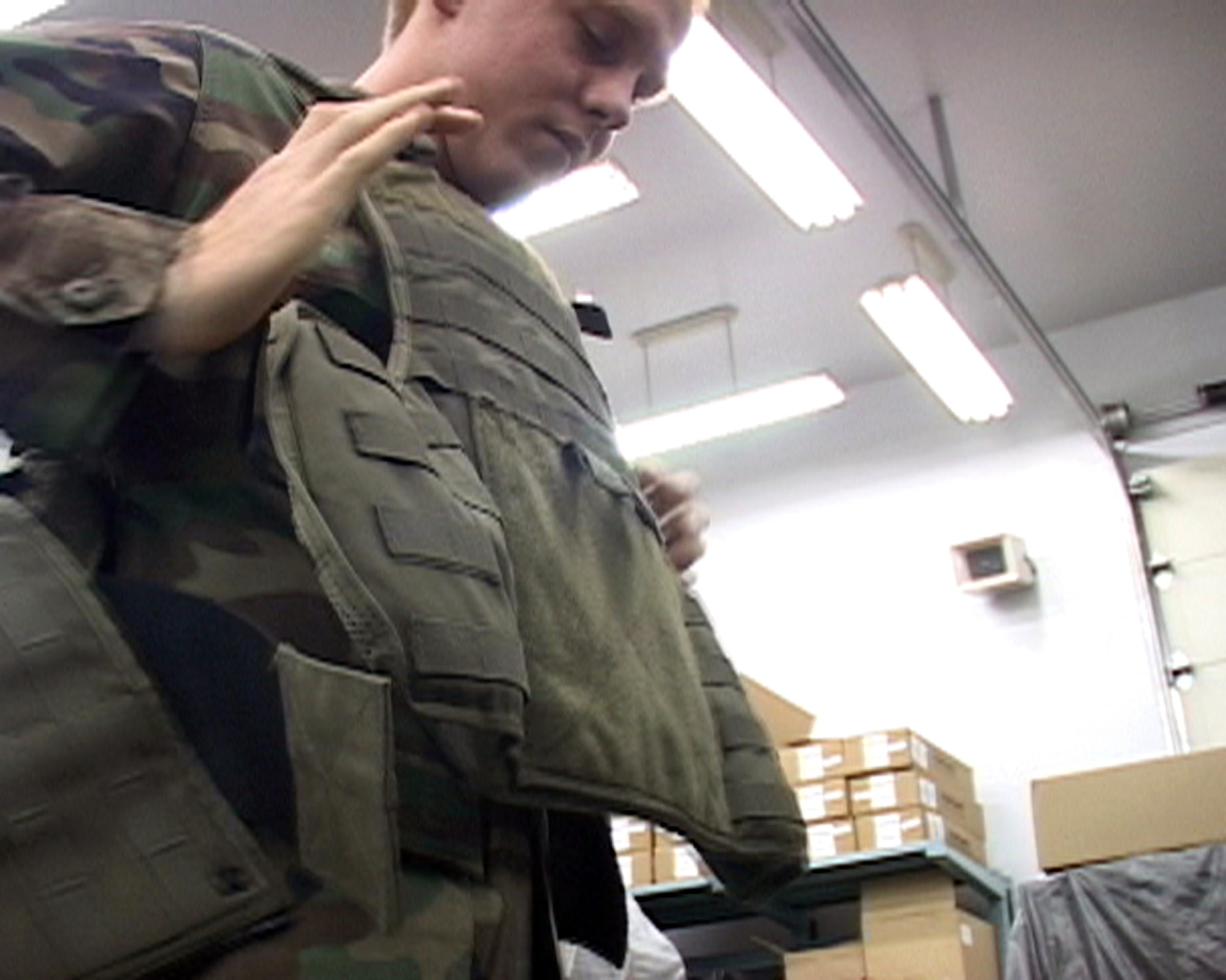 Airman Samuel Martinek tries on a flak-vest as he prepares for his upcoming deployment. Airman Martinek is assgined to the 35th Security Forces Squadron at Misawa Air Base, Japan. (U.S. Air Force photo/Seaman Shane Arrington)