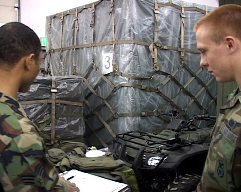 Airman Samuel Martinek inspects a pallet as he prepares for his upcoming deployment. Airman Martinek is assgined to the 35th Security Forces Squadron at Misawa Air Base, Japan. (U.S. Air Force photo/Seaman Shane Arrington)