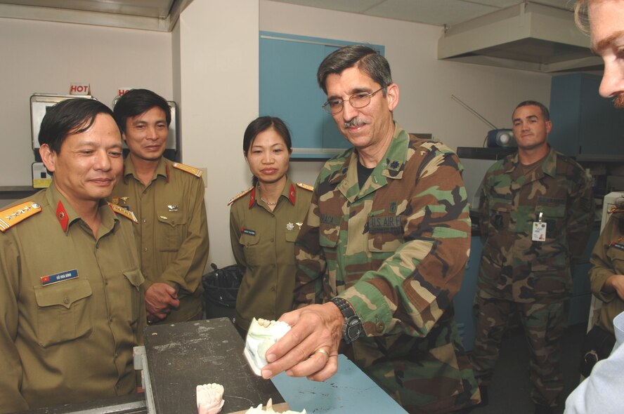 HICKAM AIR FORCE BASE, Hawaii -- Lt. Col. Guillermo Orraca, 15th Airlift Wing medical group, explains to the Vietnamese Delegation, Brig. Gen. DO Hoa Binh, Colonel TRAN Duc Thanh, and Lt. Col. NGUYEN Thi Mai Huong, of various dental services avaialable to military personnel at the 15MDG.  This visit is part of the nursing exchange program which started at the 15th Annual Asia-Pacific Military Medical Conference where the Vietnamese requested that the two countries develop a cooperative relationship between the U. S. and Vietnamese Military Nursing communities. (Air Force photo by Mark Bates)