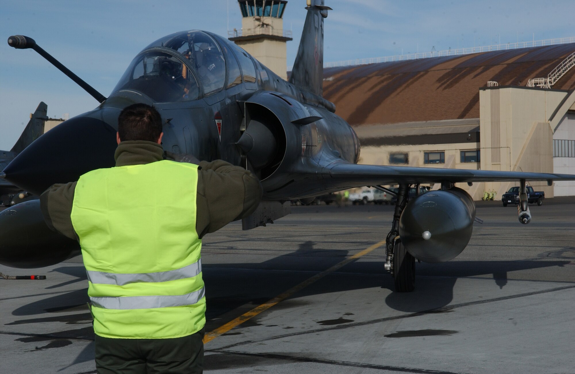 EIELSON AIR FORCE BASE, Alaska -- Technical Sgt. Vallier Julien, Armee de l'Air (French Air Force), marshalls a Mirage 2000 on the flight line on April 6 during Red Flag-Alaska 07-1. This exercise provides unique opportunities to help integrate various forces into joint, coalition, and bilateral training from simulated forward operating bases. (U.S. Air Force Photo by Airman 1st Class Jonathan Snyder) (Released)