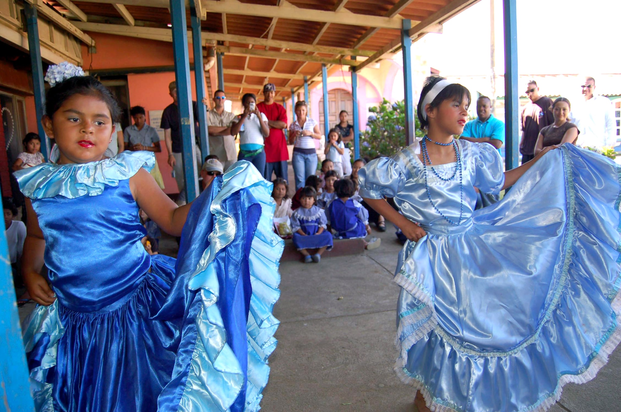 Carolina Jarquin and Guadalupe Sanabria dance for Camp RED HORSE members April 7 at the Siervas del Divino Rostro orphanage in Santa Teresa, Nicaragua. Camp RED HORSE members collected and donated more than $500, more than 80 books and more than 100 toys to two orphanages in Santa Teresa for the Easter holiday. They also put on Easter eggs hunts and spent the day playing games with the children. (U.S. Air Force/Senior Airman Jacque Lickteig)