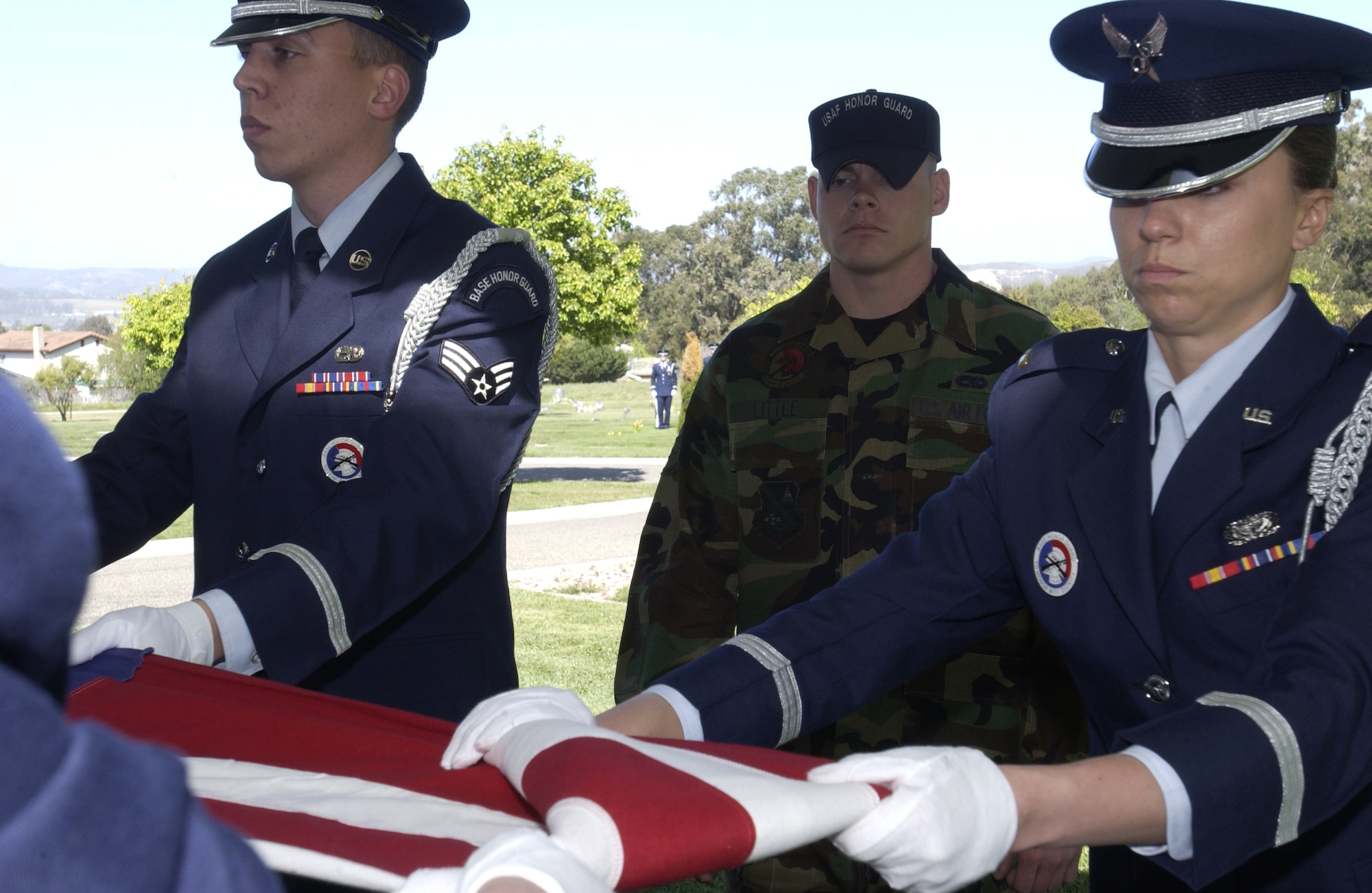 Staff Sgt. David Little, United States Air Force Honor Guard, Assistant NCOIC Base Honor Guard Program, observes as Vandenberg’s Honor Guardsmen perform the flag folding ceremony at the Lompoc Cemetery April 3. Sergeant Little visited Vandenberg with the Air Force Honor Guard’s Mobile Training Team from Bolling Air Force Base, Washington, D.C. (Photo by Staff Sgt. Christina Rumsey)