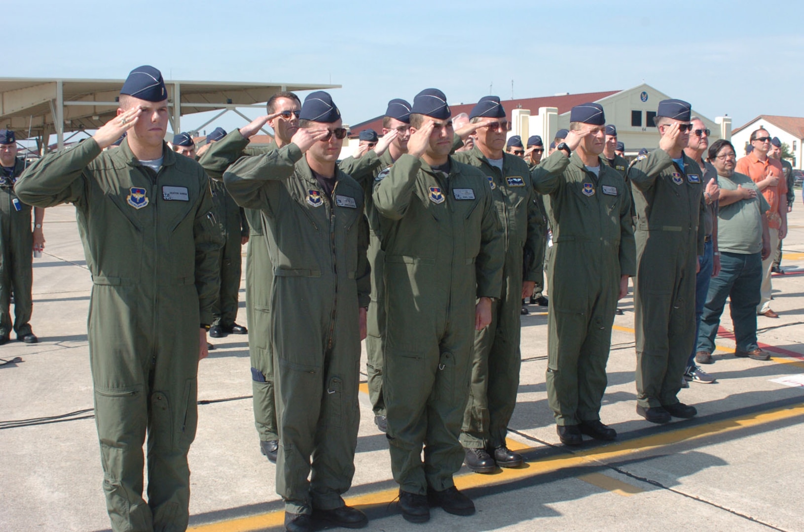 Members of the 559th Flying Training Squadron and other Randolph members salute the U.S. Flag during the playing of the National Anthem, which opened the base T-37B retirement ceremony April 6. (U.S. Air Force photo by Dave Terry)