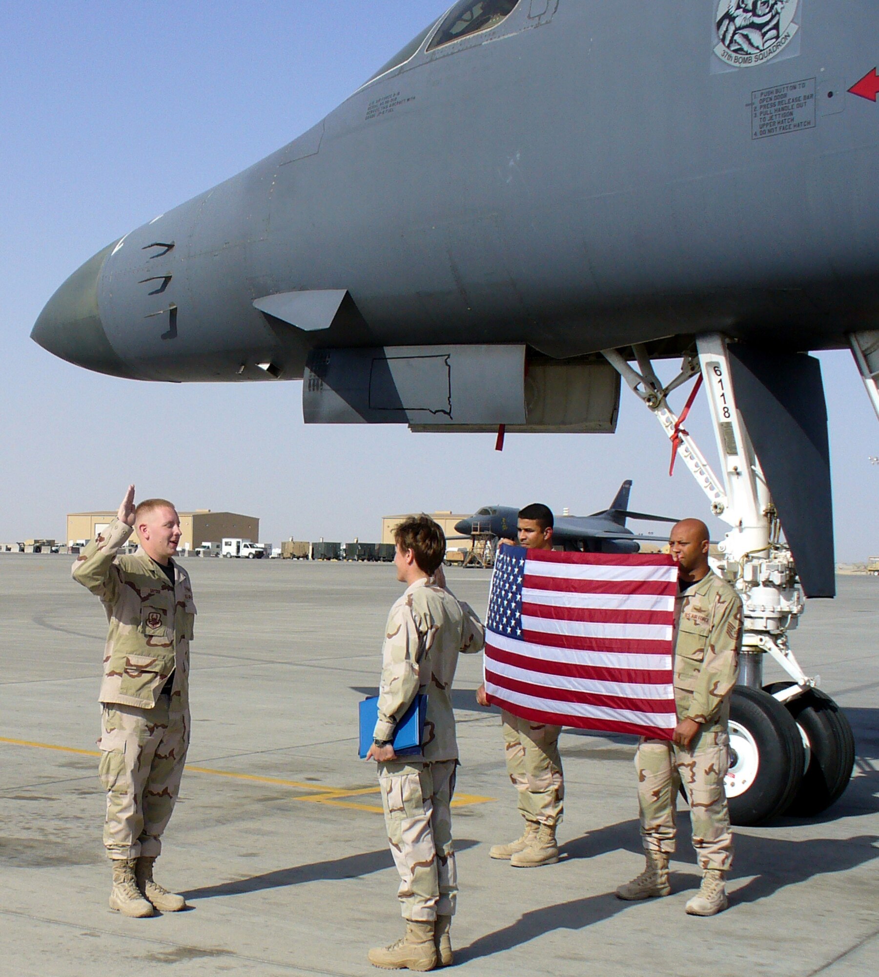 Staff Sgt. Kyle Snyder, a 21st Space Wing space operator, was promoted in a forward location in Southwest Asia, March 31. Sergeant Snyder is deployed from the 21st Operations Group in direct support of Operations Enduring Freedom and Iraqi Freedom in the U.S. Central Command area of responsibility. 
Sergeant Snyder was promoted to his new rank by Maj. Carolyn Wood, 21st OG, in front of a B-1B bomber. The flag was flown over Iraq aboard a JSTARS aircraft and was a special presentation to commemorate his promotion in the AOR.
This deployment is unique in that it is supported entirely by 21st SW, 21st OG, and 26th Space Aggressor Squadron personnel. (U.S. Air Force photo)
