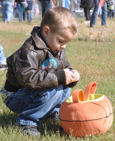 Colsen Boortz, son of Capt. Daniel Boortz, inspects the contents of an Easter egg during Moody's Easter Egg Hunt April 7. The event, which is held annually, was open for all Team Moody children between the ages of 3 months to 12 years. (U.S. Air Force photo by Staff Sgt. Joshua Jasper)
