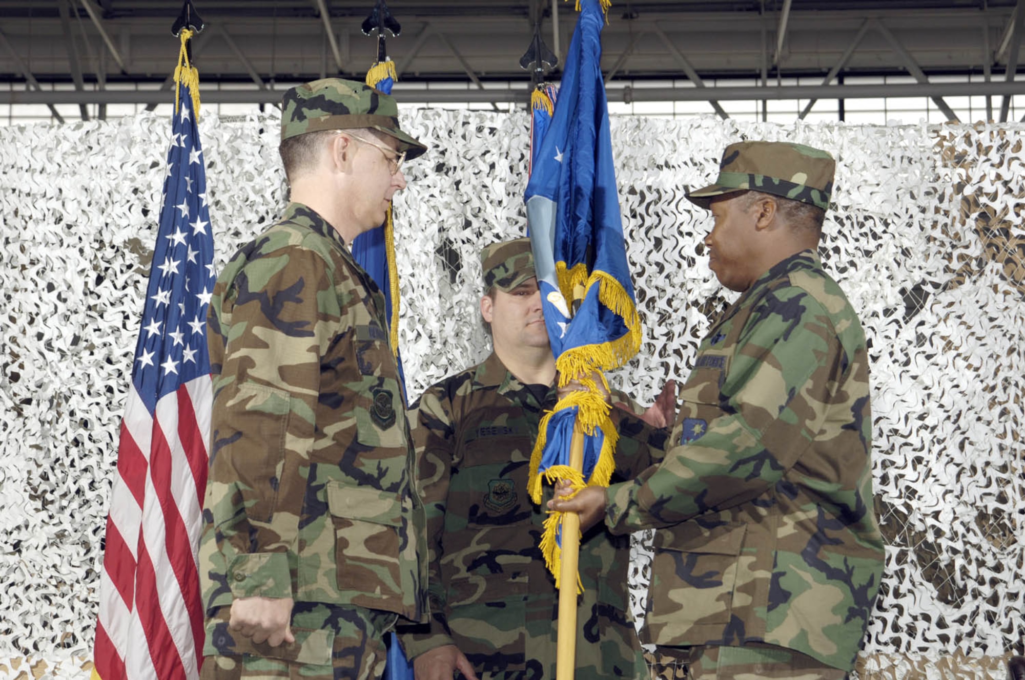 Col. Francis Cox, commander for the newly created 621st COSG accepts the flag from Col. Steven Bernard, 621st CRW commander during the activation ceremony for the new group. The group will be comprised of the 819th GSS, 1st Combat Camera Squadron, 21st Air Mobility Operations Squadron and the Air Mobility Liaison Officers.