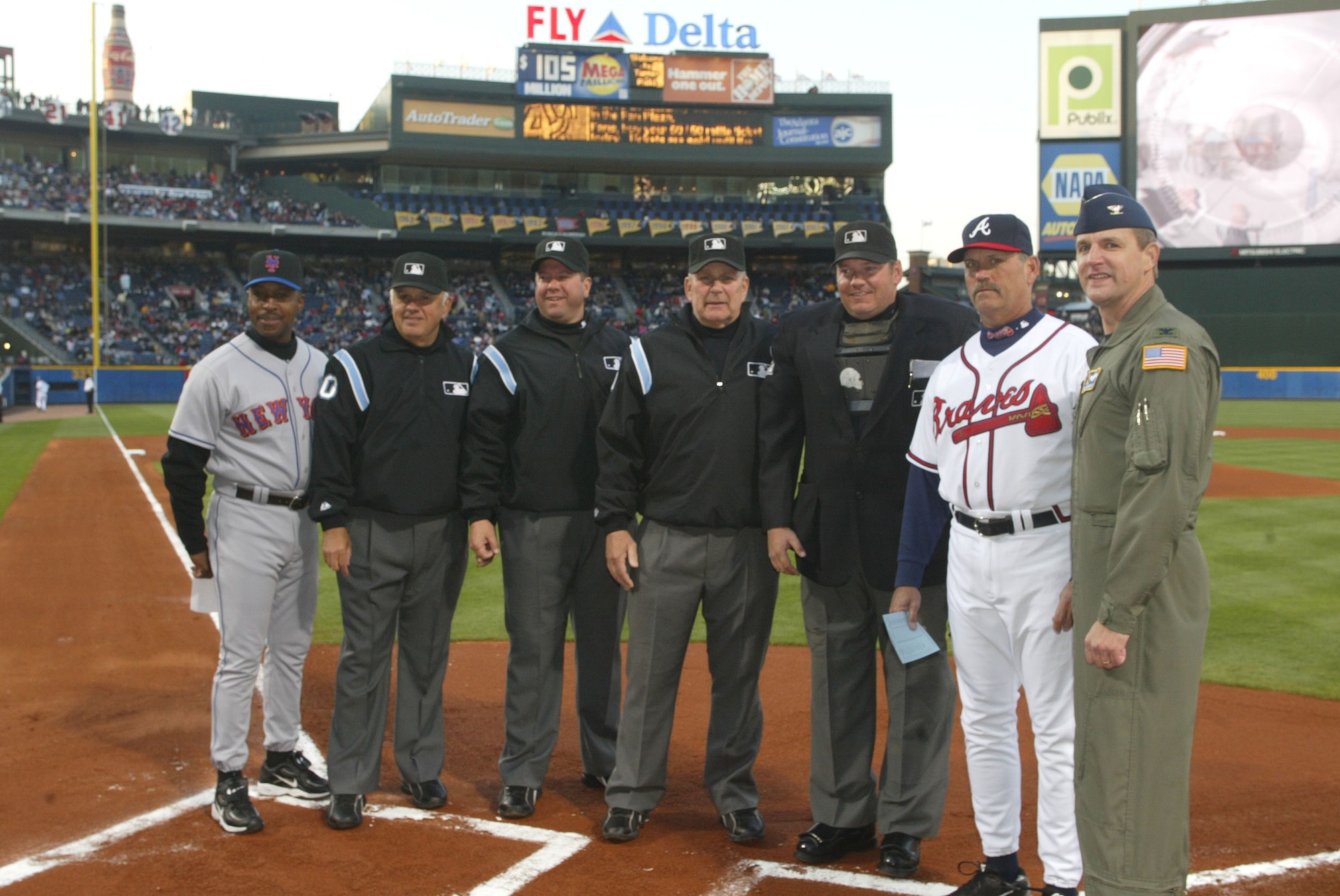 Col. Heath Nuckolls (right), named honorary team captain poses with game officials during the Atlanta Braves opening game. Colonel Nuckolls is the  commander of the 94th Airlift Wing at Dobbins Air Reserve Base, Ga.  April 6, opening game day at Turner Field, in Atlanta, was also the debut of the Air Force 60th Anniversary baseballs that will travel around the world. The baseballs will return to Turner Field within the month of September.  The Heritage to Horizons events throughout the year lead up to Atlanta Air Force Week, Oct. 8-14. (U.S. Air Force photo/Don Peek)