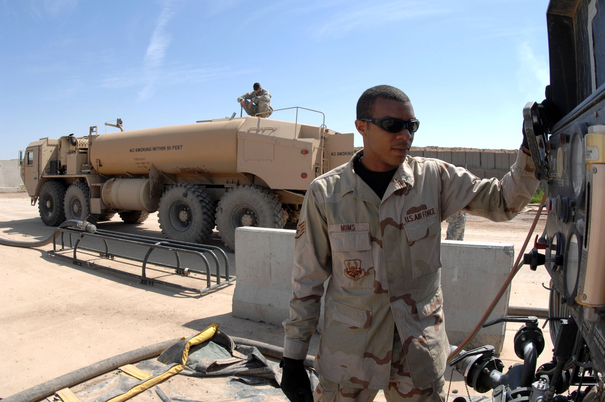 Staff Sgt. Edward Mims watches the gauges on an R-14 refueler system as he fuels an Army truck April 5 while Army Spc. John Goughenour monitors the amount being pumped at Kirkuk Air Base in Iraq. Sergeant Mims is a fuels supervisor with the 506th Expeditionary Logistics Readiness Squadron and Specialist Goughenour is a member of Alpha Company, 325th Brigade Support Battalion at Schofield Barracks, Hawaii. (U.S. Air Force photo/Senior Airman Bradley A. Lail)
