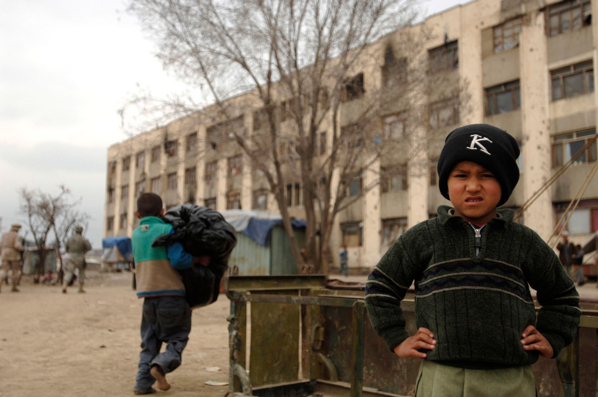 A refugee child stands in front of his home April 8. More than 1,000 refugees live in this building in Dar Ul Aman near Kabul, Afghanistan. The Volunteer Community Relations program distributes clothes, food and toys here every month with the help of donated items from U.S. citizens. (U.S. Air Force photo/Tech. Sgt. Cecilio M. Ricardo Jr.)
