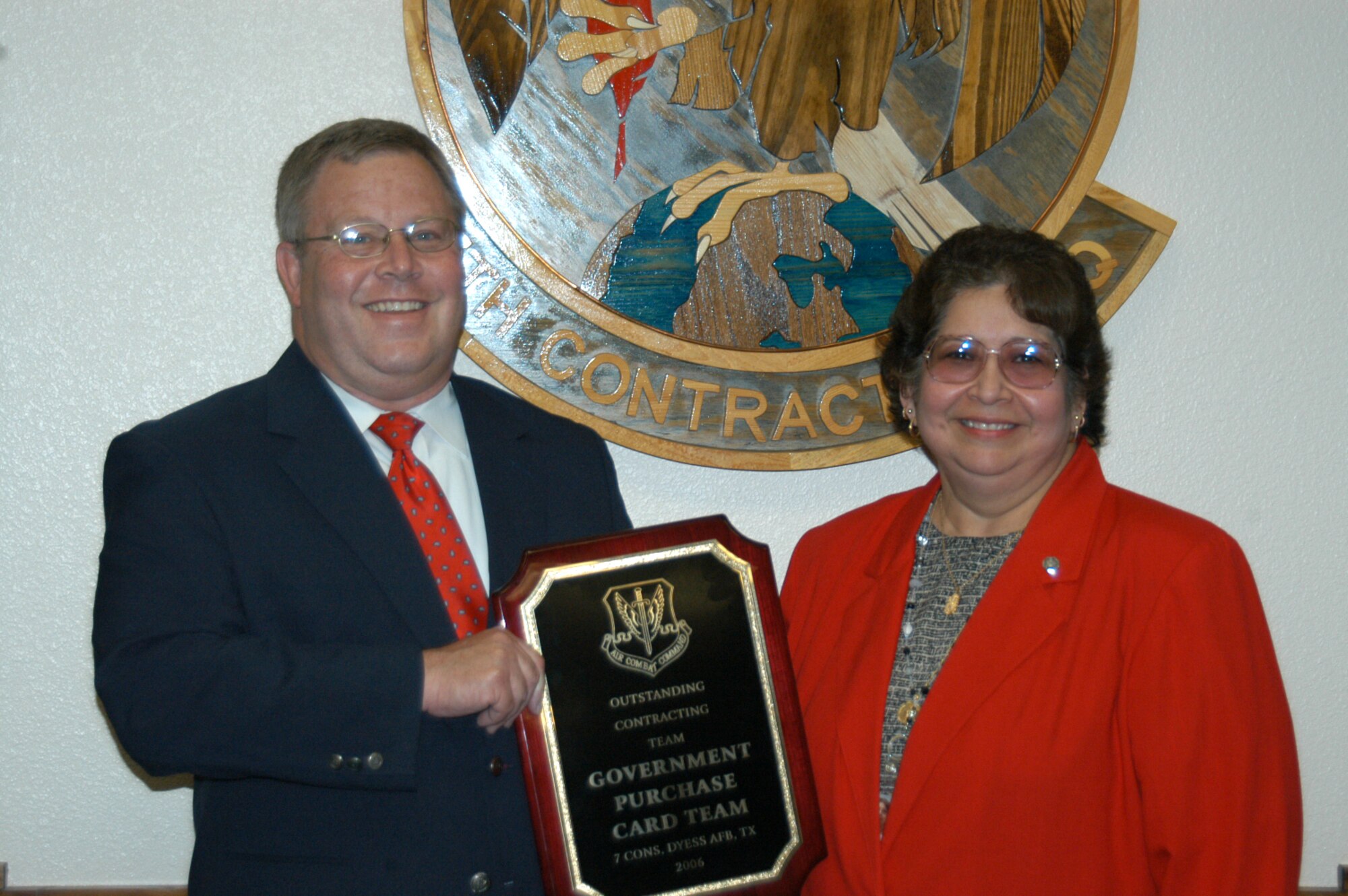 Mrs. Lamar Campos (right) and Mr. Donald Plumley, 7th Contracting Squadron, won the 2006 Air Combat Command Contracting Team of the Year Award and were presented with a plaque April 5.  Both Team Dyess members are Government Purchase Card program managers for the entire base and were noted noted as superior performers during the recent headquarters ACC unit compliance inspection. (Photo by Airman 1st Class Carolyn Viss)
