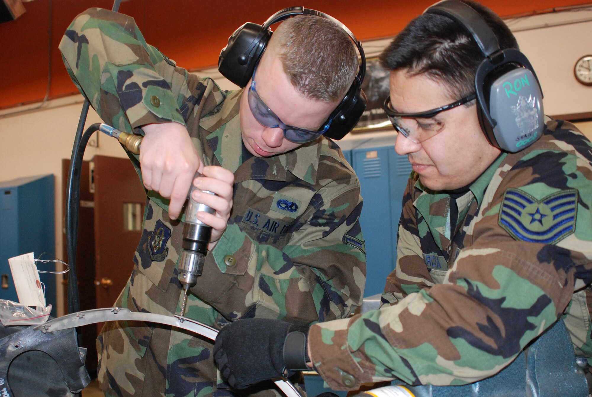 Tech. Sgt. Ronald Garcia instructs Airman 1st Class Travis Moore, both of the 301st Aircraft Structures Shop, in proper drilling technique of aircraft parts. This instruction is an important part of all Air Force Reserve's aircraft structural maintenance up-grade training requirements. (U.S. Air Force Photo/Tech. Sgt. Stephen Bailey)
