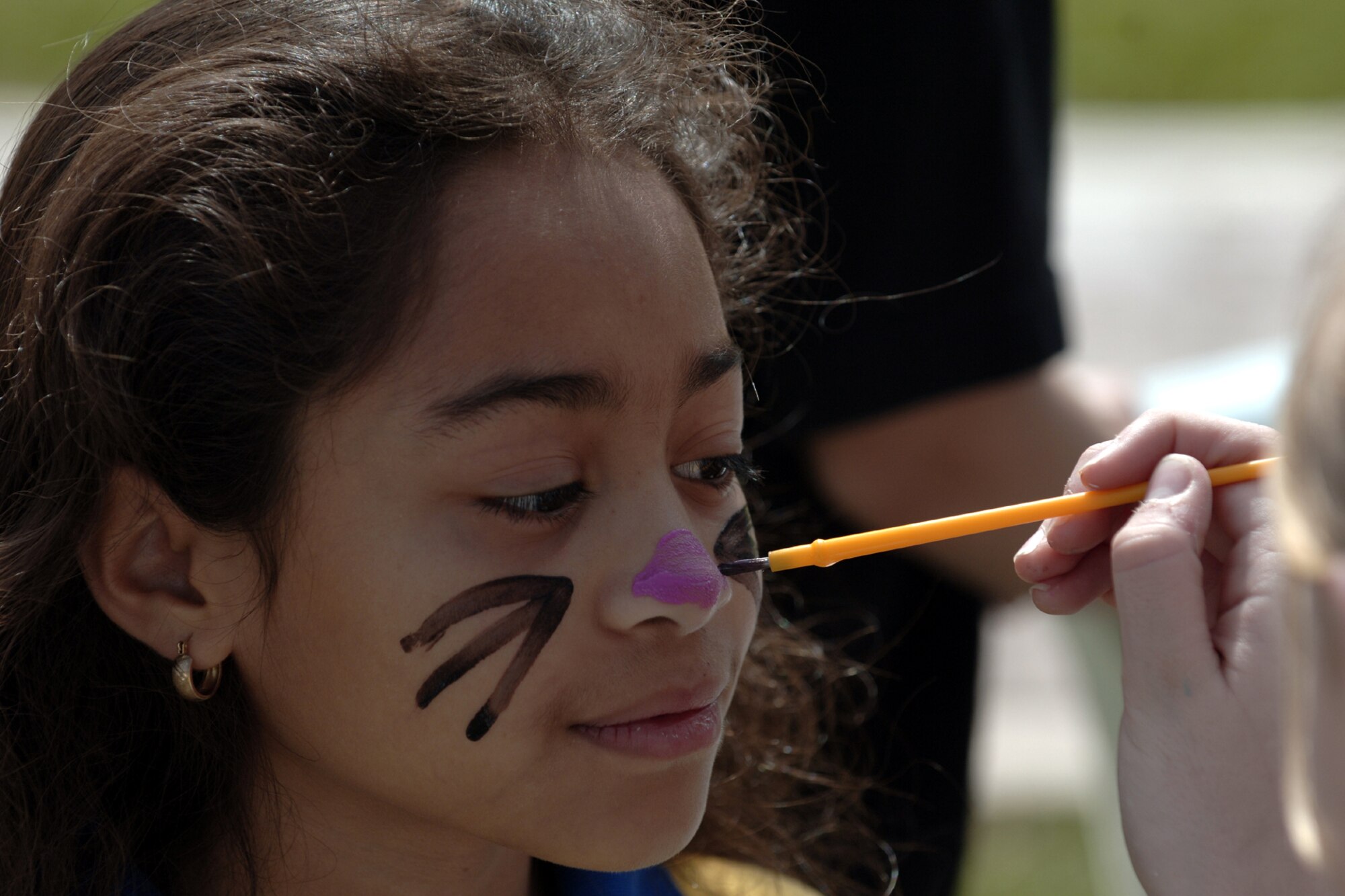 Sasha Merritt has her face painted during the Easter Festivities at Arkadas Park April 7.  The event which was put together by members of the youth center included an egg hunt, games, music, face painting, and crafts for the kids.  The Easter Bunny also made an appearance to hand out Easter eggs, and to take photos with children and adults.  (U. S. Air Force photo by Airman 1st Class Nathan W. Lipscomb)