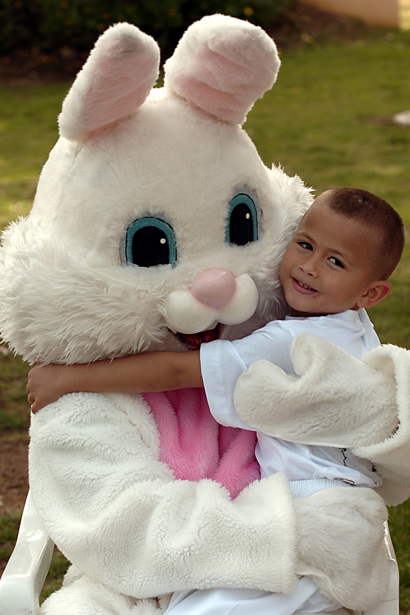 Zachary Borbon gives the Easter bunny a hug during the Easter Festivities April 7.  The event which was put together by members of the youth center included an egg hunt, games, music, face painting, and crafts for the kids.  The Easter Bunny also made an appearance to hand out Easter eggs, and to take photos with children and adults.  (U. S. Air Force photo by Airman 1st Class Nathan W. Lipscomb)