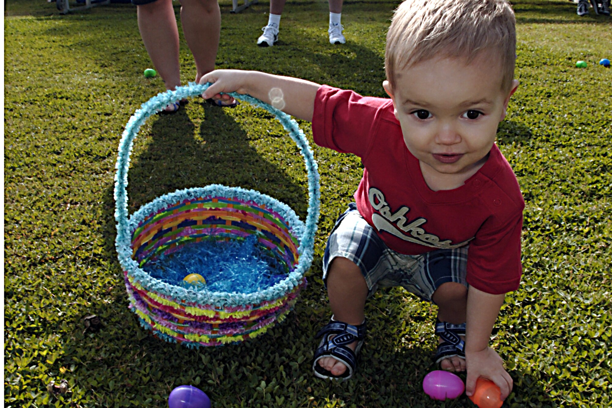 Avery Thomas hunts down Easter eggs during the Easter Festivities, April 7.  The event which was put together by members of the youth center included an egg hunt, games, music, face painting, and crafts for the kids.  The Easter Bunny also made an appearance to hand out Easter eggs, and to take photos with children and adults.  (U. S. Air Force photo by Airman 1st Class Nathan W. Lipscomb)