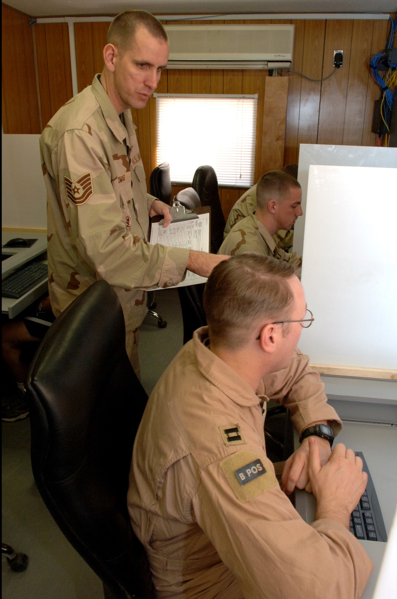 Tech. Sgt. Jack Thomas prepares 332nd Air Expeditionary Wing Airmen for a computer-based test at Balad Air Base, Iraq. He is the 332nd Expeditionary Services Squadron's test control officer. (U. S. Air Force photo/Staff Sgt. Michael R. Holzworth)