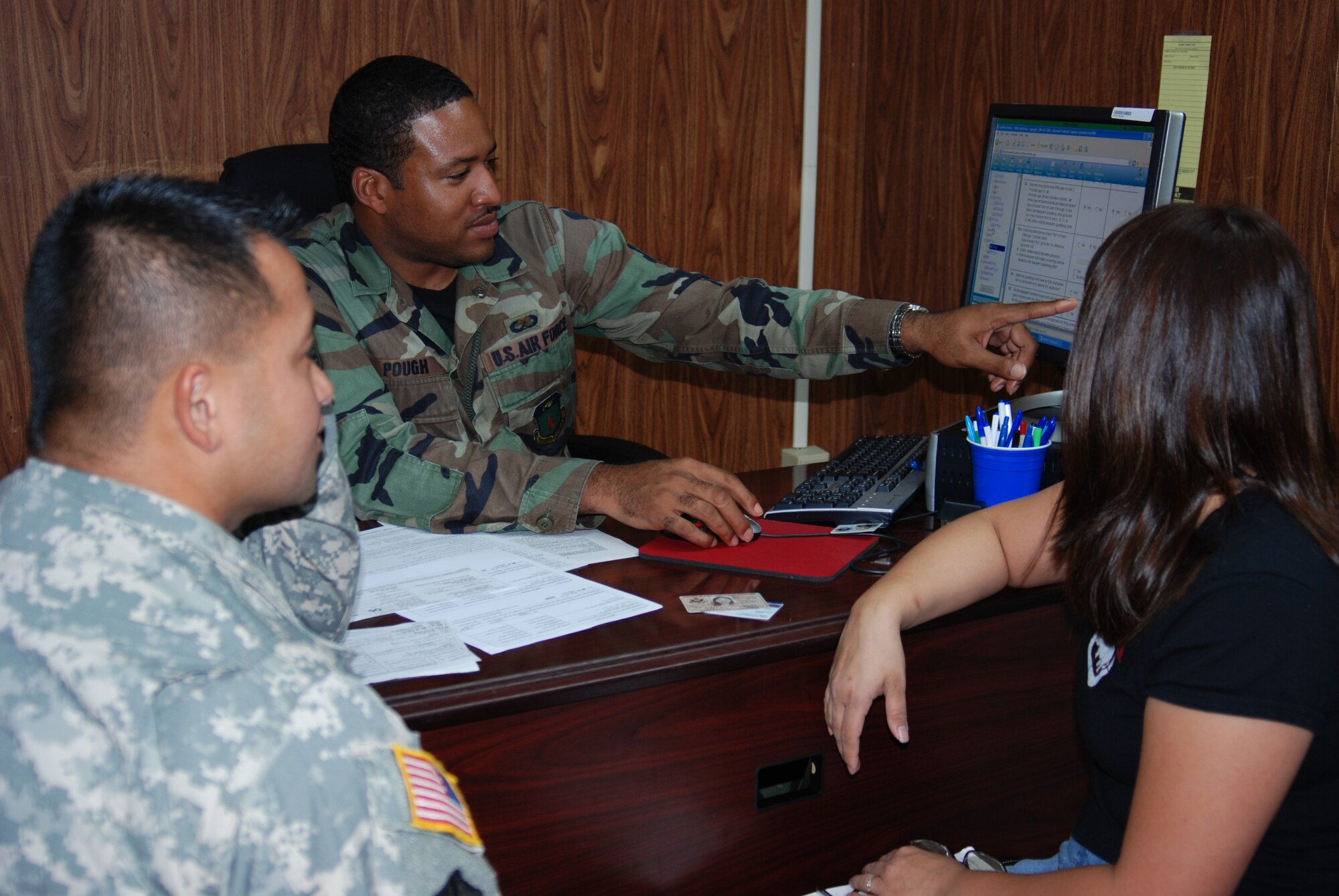Staff Sgt. Michael Pough, tax center volunteer, helps customers prepare their tax return.  The tax center is a resource for base employees to obtain free tax assistance. (Photo by Master Sgt. Ann Bennett/36th Wing Public Affairs)