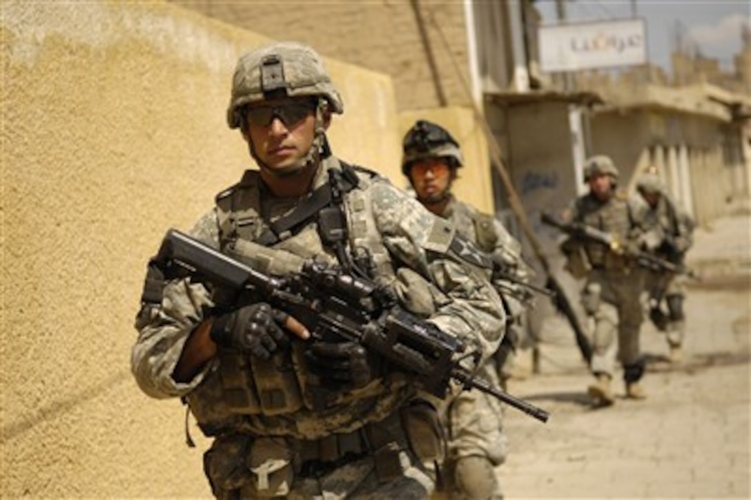 U.S. Army Sgt. 1st Class Joseph Labrosse leads his squad during a cordon and search for weapons caches and insurgents in Old Baqubah, Iraq, on April 2, 2007. Labrosse is from the 5th Battalion, 20th Infantry Regiment, 3rd Stryker Brigade Combat Team, 2nd Infantry Division.  