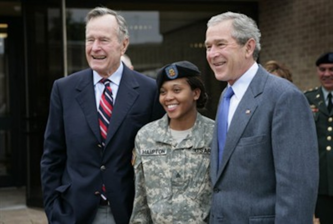 President George W. Bush and his father, former President George H.W. Bush, stand with U.S. Army Sgt. Shenika Hampton after attending an Easter church service at Fort Hood, Texas, April 8, 2007.